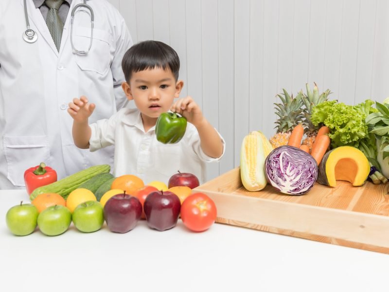 Healthy and nutrition concept. Kid learning about nutrition with doctor to choose eating fresh fruits and vegetables.
